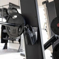 CLNCH Magnetic Bottle Bag mounted to power rack next to 45LB plate